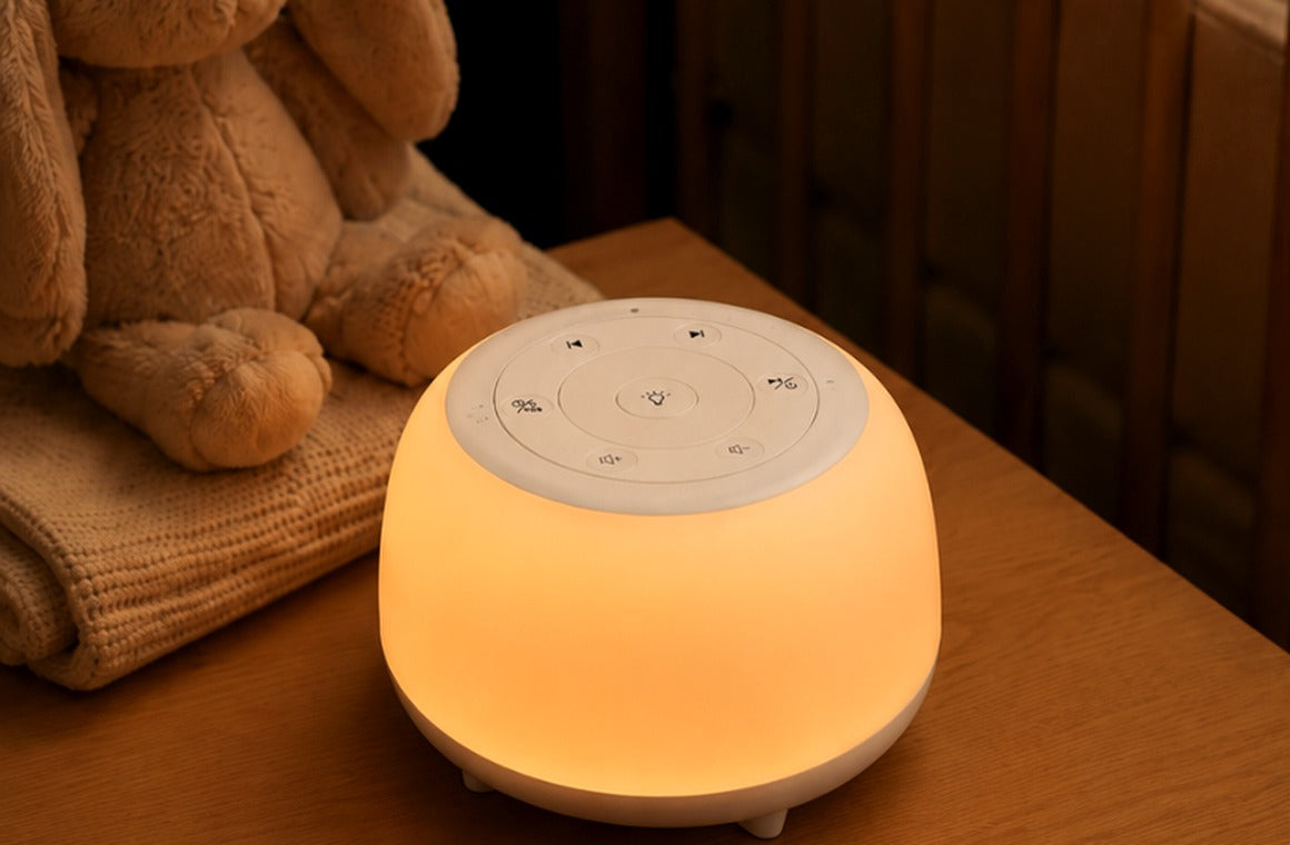 Warm glowing HEYAXA night light beside a quiet nursery crib